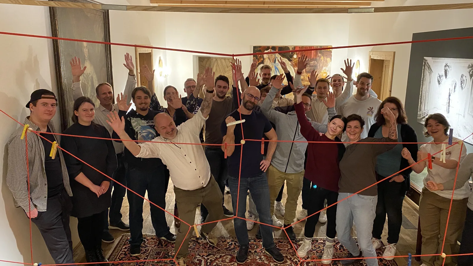 Team bei einer Teamentwicklung auf Gut Schörghof mit rotem Seilnetz